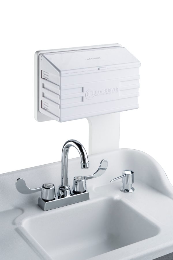 White ABS countertop with attached m-fold towel dispenser and built-in soap dispenser